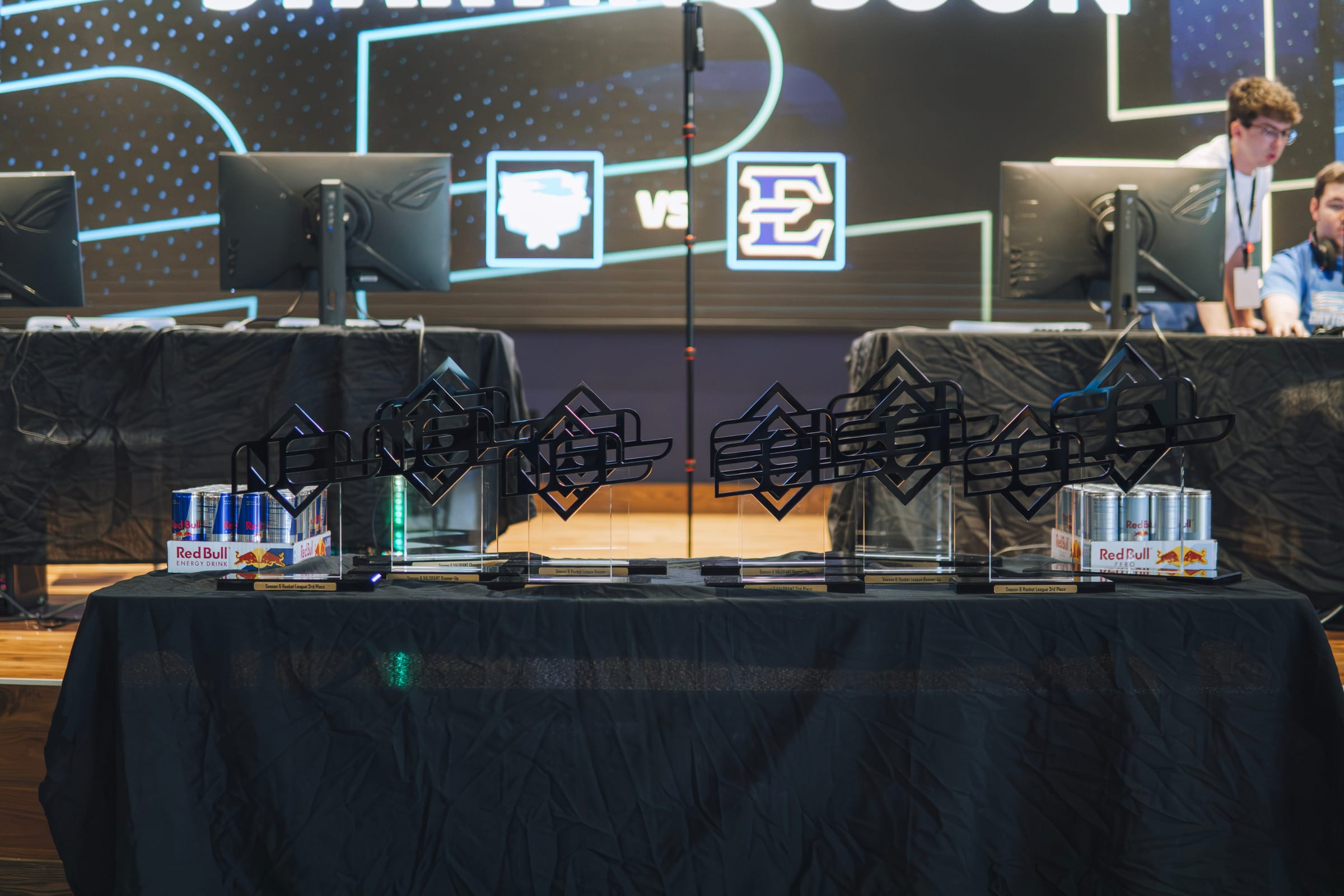 Custom SEL and NEL championship trophies on a finals table
